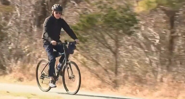 Joe Biden Leisurely Rides Bike by the Beach Despite Multiple Crises (VIDEO)